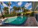 Relaxing pool area amid tropical foliage, complete with patio and lush landscaping at 3960 13Th Ne Way, St Petersburg, FL 33703