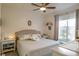 Comfortable bedroom with a large window, bedside tables, and a decorative floral comforter at 4221 W Spruce St # 2205, Tampa, FL 33607