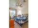Inviting bedroom with a ceiling fan, computer desk, and large window with natural light at 4221 W Spruce St # 2205, Tampa, FL 33607