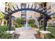 Charming courtyard featuring a decorative fountain, pergola, and lush greenery at 4221 W Spruce St # 2205, Tampa, FL 33607