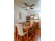 Formal dining room with wood table and chairs under a ceiling fan and light fixture at 4221 W Spruce St # 2205, Tampa, FL 33607