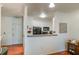 A cozy kitchen featuring white cabinets and a breakfast bar, open to the living area at 4221 W Spruce St # 2205, Tampa, FL 33607