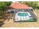 Aerial view of a home showcasing a screened-in pool, patio, and well-maintained yard at 5140 Kirkwood Ave, Spring Hill, FL 34608