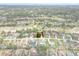 Focused aerial view of home with red roof, situated among neighborhood residences and a golf course at 5140 Kirkwood Ave, Spring Hill, FL 34608