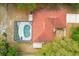 Aerial view of a house with a screened pool enclosure and a red roof at 5140 Kirkwood Ave, Spring Hill, FL 34608