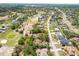 Aerial view of homes near a golf course with lush greenery and roadways at 5140 Kirkwood Ave, Spring Hill, FL 34608