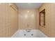 Clean white bathtub with tan tile surround and built-in niche for toiletries at 5140 Kirkwood Ave, Spring Hill, FL 34608