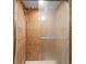 Modern walk-in shower with brown tile and glass door with chrome finishings at 5140 Kirkwood Ave, Spring Hill, FL 34608