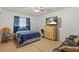 Cozy bedroom featuring a ceiling fan and a large window for natural light at 5140 Kirkwood Ave, Spring Hill, FL 34608