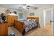 Cozy bedroom with ceiling fan, large bed, and a wooden dresser, providing a relaxing atmosphere at 5140 Kirkwood Ave, Spring Hill, FL 34608