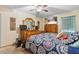 Bright bedroom featuring a ceiling fan, large bed, and wooden dresser at 5140 Kirkwood Ave, Spring Hill, FL 34608
