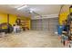 Spacious two car garage perfect for storage, with yellow painted walls and concrete floor at 5140 Kirkwood Ave, Spring Hill, FL 34608