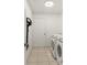 Convenient laundry room with washer, dryer, white walls, and a tiled floor at 5140 Kirkwood Ave, Spring Hill, FL 34608