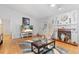 Inviting living room with tile floors, fireplace, TV, and a cozy seating area at 5140 Kirkwood Ave, Spring Hill, FL 34608