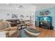 Spacious living room featuring vaulted ceilings, tile flooring, stylish furnishings, and a large aquarium at 5140 Kirkwood Ave, Spring Hill, FL 34608