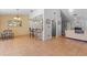 Open-concept living space with tile flooring, bar seating, stainless steel appliances, and access to the living room at 5140 Kirkwood Ave, Spring Hill, FL 34608