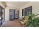 Covered patio features sliding glass doors, plants, and comfortable seating area at 5140 Kirkwood Ave, Spring Hill, FL 34608