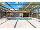 Sparkling pool area with covered enclosure, outdoor dining, and space for entertaining at 5140 Kirkwood Ave, Spring Hill, FL 34608