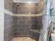 Tiled shower with river rock floor and a corner bench at 5140 Kirkwood Ave, Spring Hill, FL 34608