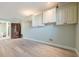 Living room featuring hard wood floors, white cabinets for storage, recessed lighting, and pale green paint at 5517 Jobeth Dr, New Port Richey, FL 34652