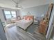 Bright bedroom with calming blue-gray walls, water view, and comfortable furnishings and decorations at 6020 Shore S Blvd # 902, Gulfport, FL 33707