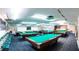 The billiard room includes multiple pool tables and chairs, and decor creating a great atmosphere for game nights at 6020 Shore S Blvd # 902, Gulfport, FL 33707