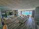 Spacious living room features wood floors, a ceiling fan, and a large window overlooking the water at 6020 Shore S Blvd # 902, Gulfport, FL 33707