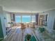 Cozy living room showcasing beautiful water views from the expansive windows and comfortable seating arrangement at 6020 Shore S Blvd # 902, Gulfport, FL 33707