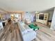 Bright living room with wood flooring, ceiling fan, and view into dining area creating an inviting space at 6020 Shore S Blvd # 902, Gulfport, FL 33707