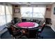 The poker room includes a round table and chairs, and decor creating a great atmosphere for game nights at 6020 Shore S Blvd # 902, Gulfport, FL 33707
