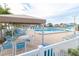 Resort-style pool area with lounge chairs, tables, and shaded cabanas, perfect for relaxation at 6020 Shore S Blvd # 902, Gulfport, FL 33707