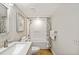 Bathroom with a tub and shower combination, a white-tiled wall, and granite vanity at 6059 Bahia Del Mar Blvd # 141, St Petersburg, FL 33715