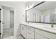 Elegant bathroom with double vanity, large mirror, and view into a walk-in closet at 6605 N Nebraska Ave # 28, Tampa, FL 33604