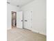 Empty bedroom features light colored patterned carpet, white walls, and double doors at 6605 N Nebraska Ave # 28, Tampa, FL 33604