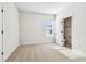 Small bedroom featuring a light colored patterned carpet, white walls, and bright sunlight through windows at 6605 N Nebraska Ave # 28, Tampa, FL 33604