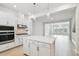 Modern kitchen with island, stainless steel appliances, light wood floors, and open layout at 6605 N Nebraska Ave # 28, Tampa, FL 33604
