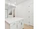 Kitchen island with white cabinets, modern hardware, quartz countertop, and pendant lights at 6605 N Nebraska Ave # 28, Tampa, FL 33604