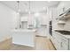 Bright white kitchen with modern appliances, an island, and sleek cabinetry at 6605 N Nebraska Ave # 28, Tampa, FL 33604
