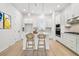 Bright kitchen features a central island, modern appliances, pendant lighting, and ample white cabinetry at 6605 N Nebraska Ave # 28, Tampa, FL 33604