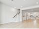 Bright living room with light hardwood floors connects to a modern, all-white kitchen at 6605 N Nebraska Ave # 28, Tampa, FL 33604