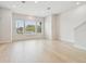 Spacious living room with light wood floors, large windows, and recessed lighting at 6605 N Nebraska Ave # 28, Tampa, FL 33604
