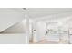 Spacious living area with a view of the kitchen, stairs, and modern finishes at 6605 N Nebraska Ave # 28, Tampa, FL 33604