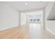 Bright living room with light wood floors and large windows allowing ample natural light at 6605 N Nebraska Ave # 28, Tampa, FL 33604