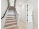 Bright home interior featuring a staircase with light wood treads, white risers and walls at 6605 N Nebraska Ave # 28, Tampa, FL 33604