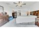 Spacious main bedroom with neutral walls, carpeted floors, ceiling fan, and furniture, including dressers and a bed at 6727 Bar S Bar Trail, Zephyrhills, FL 33541