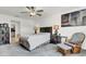 Comfortable main bedroom with carpeted floors, neutral walls, ceiling fan, and furniture including dressers, bed and sitting chair at 6727 Bar S Bar Trail, Zephyrhills, FL 33541