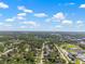 Expansive aerial view of a suburban area featuring a lake and a distant cityscape at 7401 Hancock St, Riverview, FL 33578