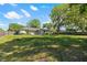 Large backyard with manicured lawn, mature trees, and fence line at 7401 Hancock St, Riverview, FL 33578