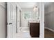 Bathroom featuring double vanity, granite counters, decorative mirrors, and shower at 7401 Hancock St, Riverview, FL 33578