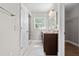 Bathroom featuring double vanity, granite counters, decorative mirrors, and shower at 7401 Hancock St, Riverview, FL 33578